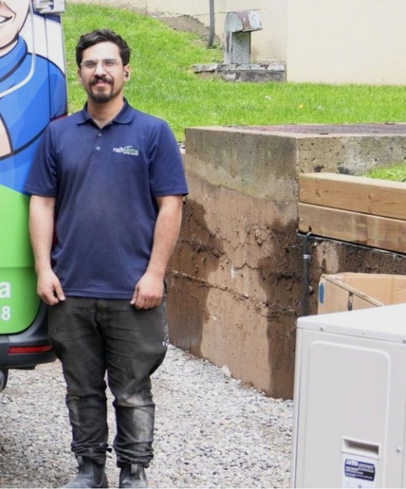 Nexklima technician standing next to a service van